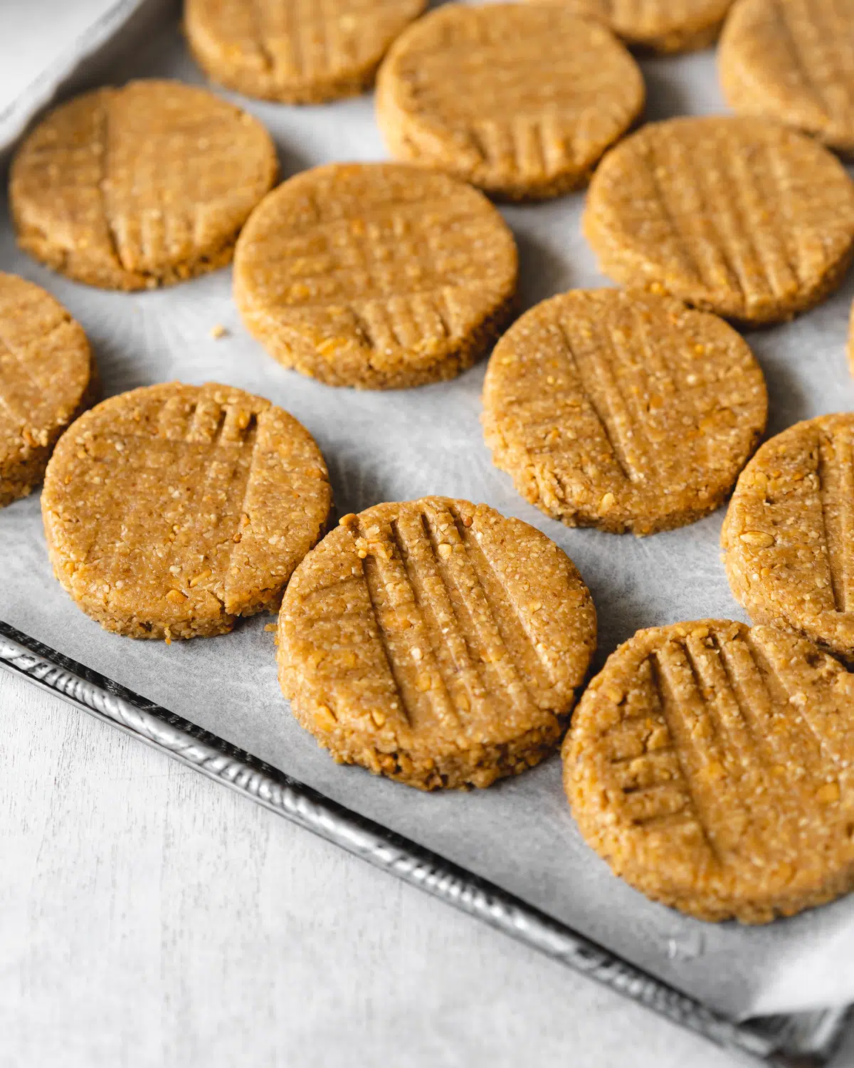 vegan peanut butter cookies on a baking sheet with parchment paper.