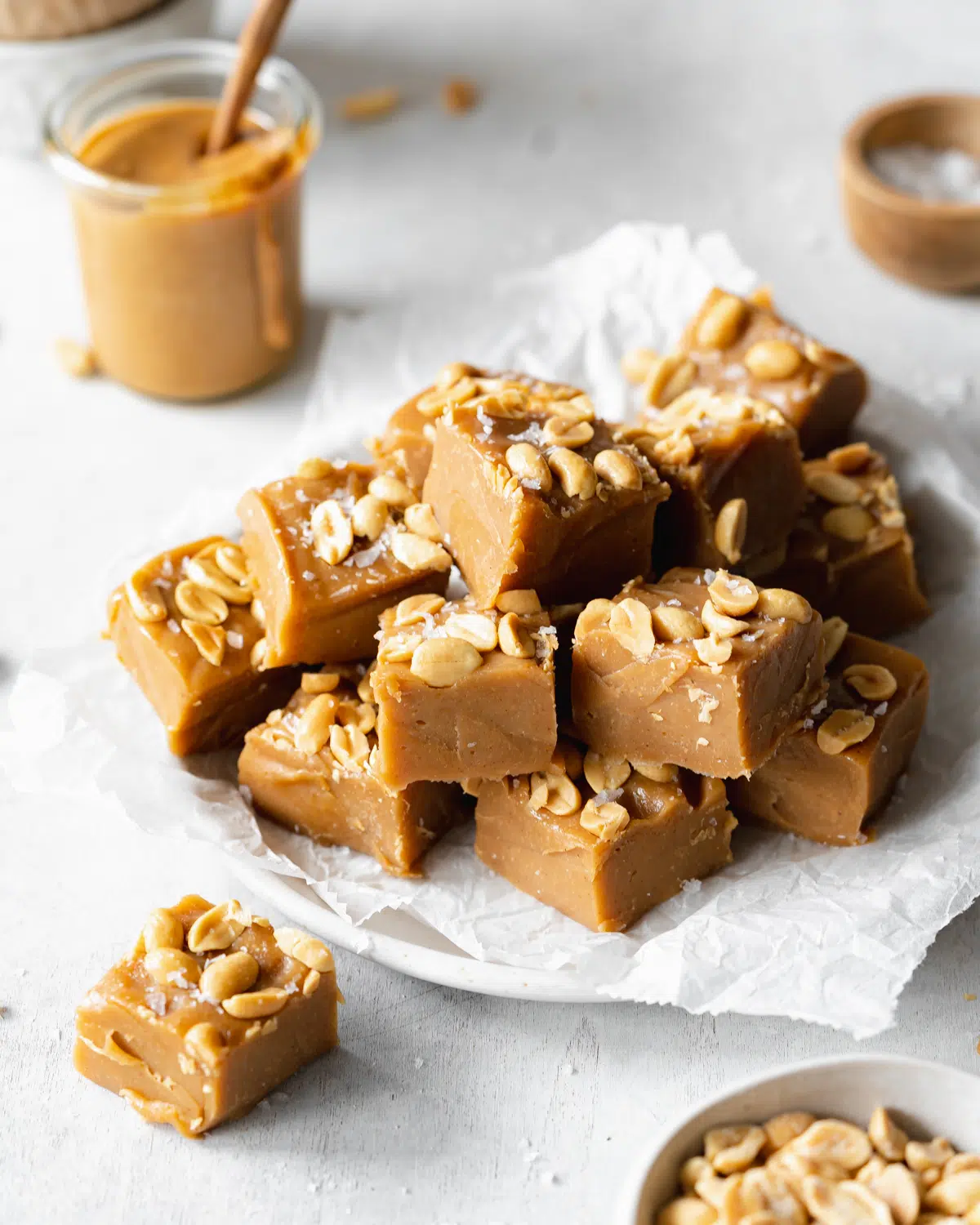peanut butter fudge on a plate with parchment paper.