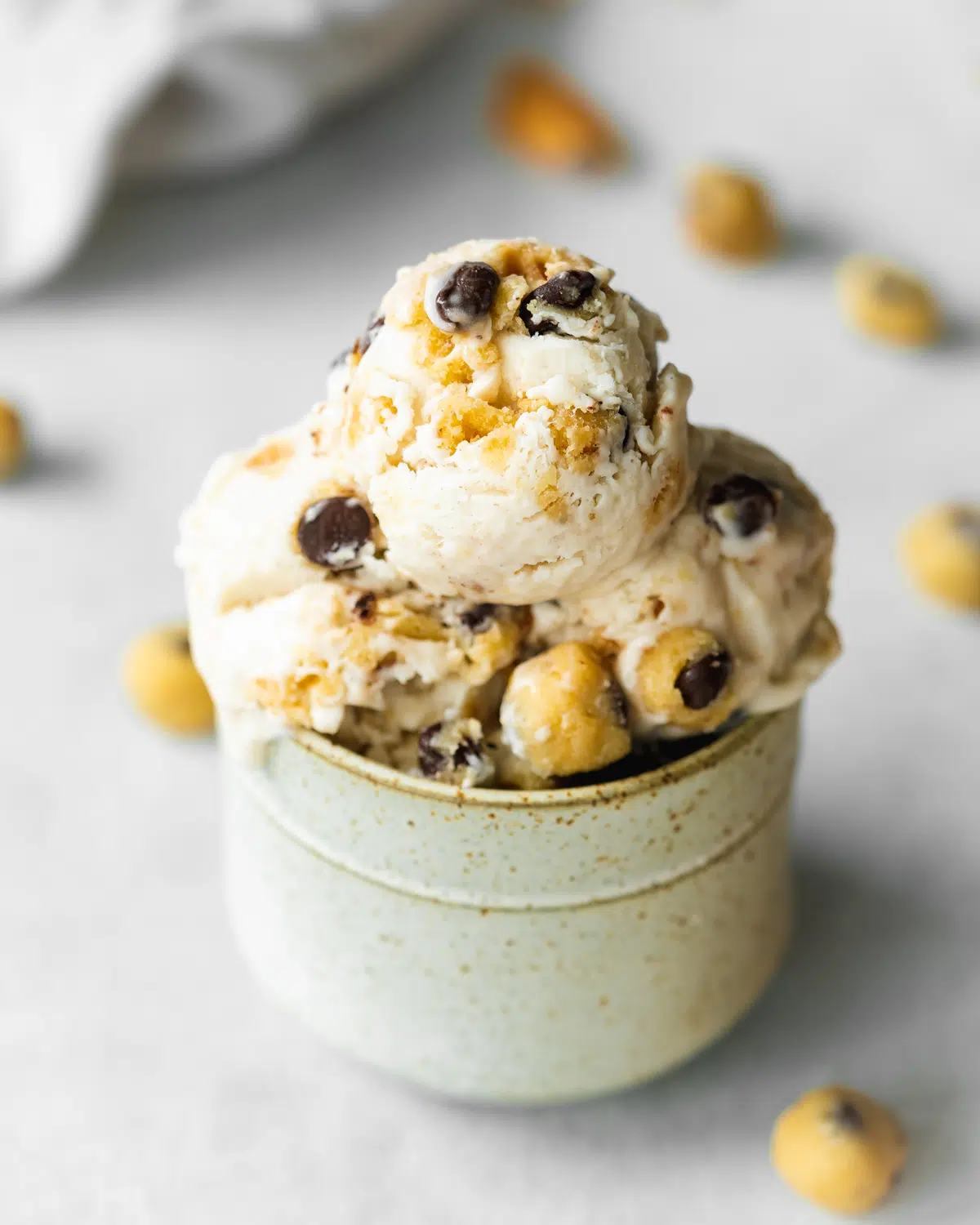 scoops of cookie dough ice cream in a ceramic jar.