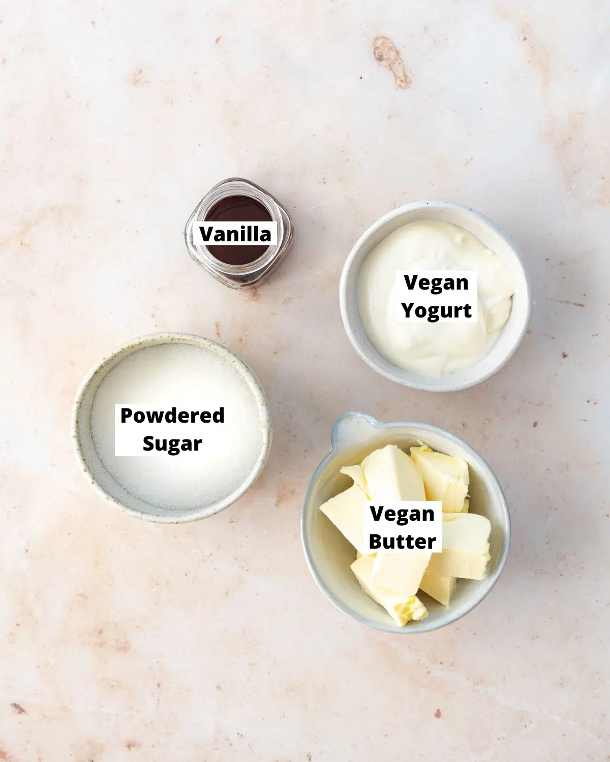 ingredients to make vegan vegan frosting measured out in small bowls.