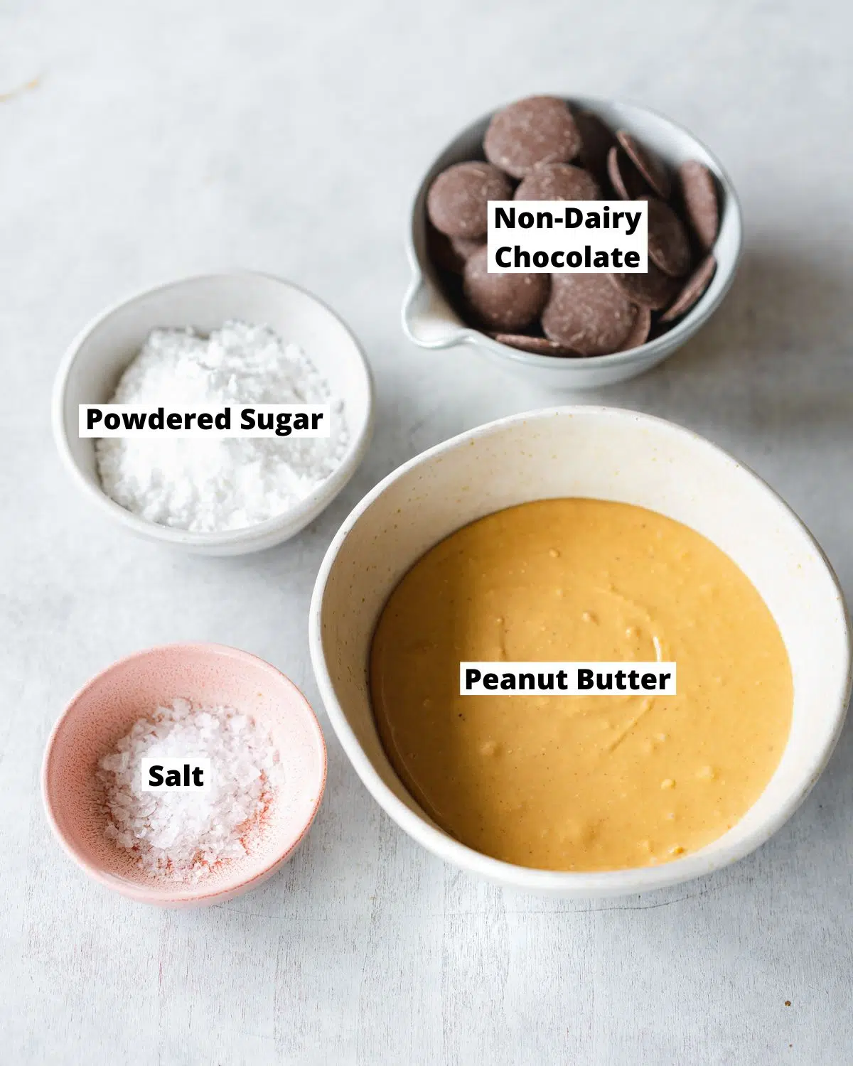 ingredients for reese's cups measured out in bowls.