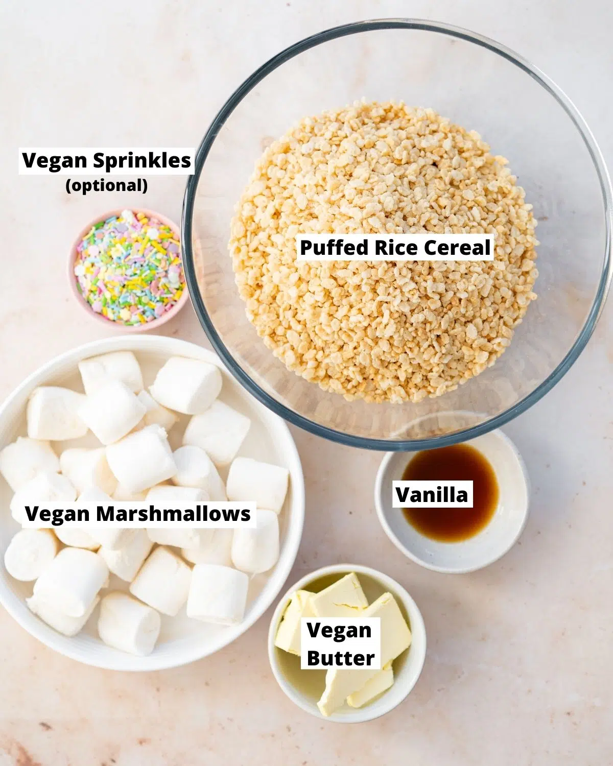 ingredients for vegan rice krispie treats measured out in bowls.