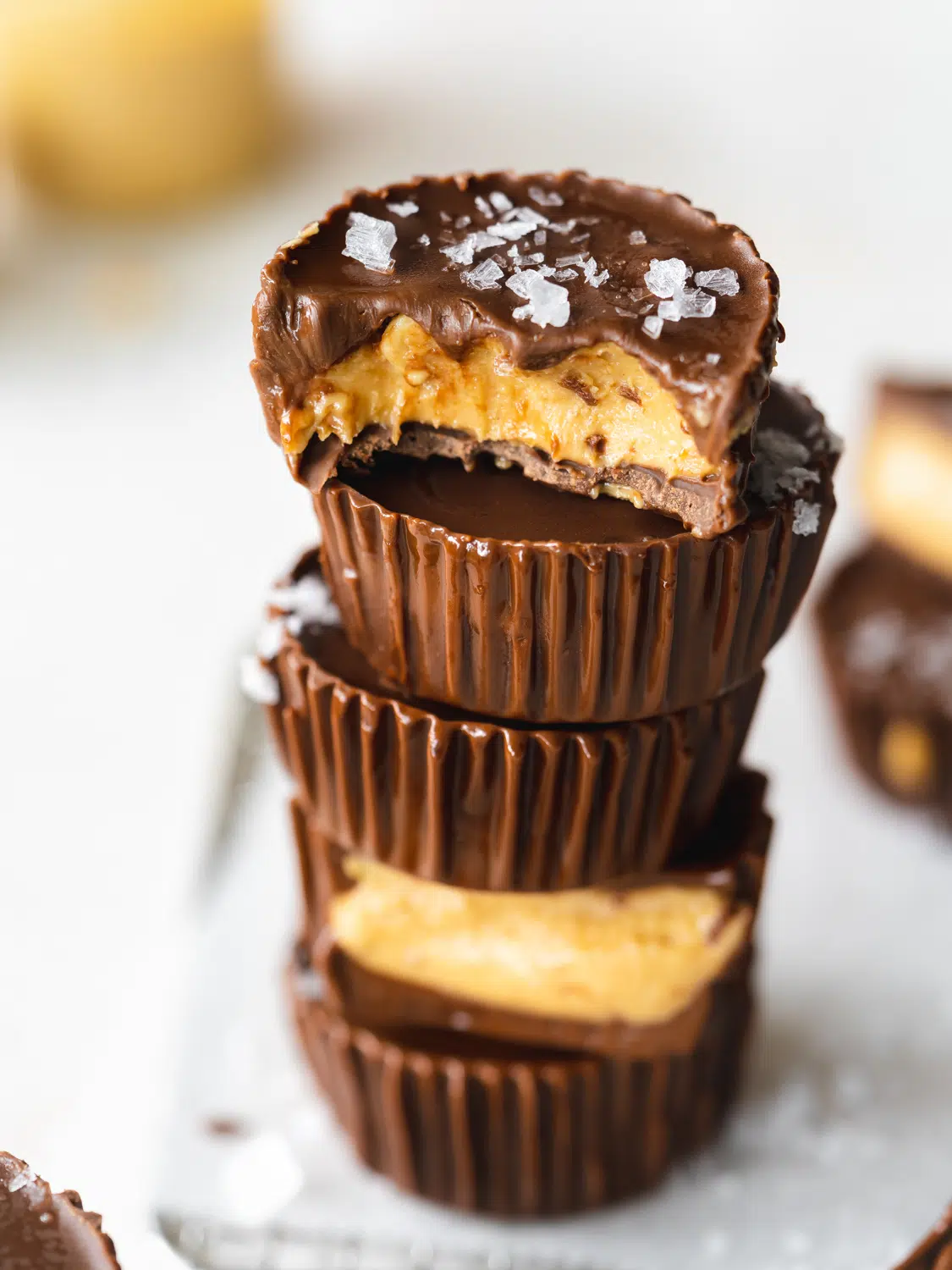 stack of peanut butter cups with sea salt flakes on top.