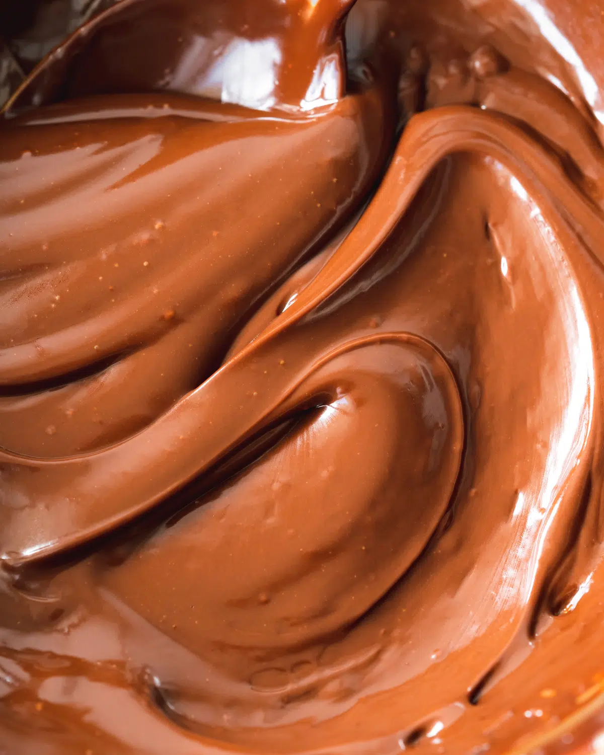 non-dairy chocolate ganache smoothed out with a spoon.