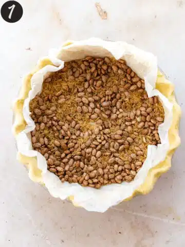 pie crust filled with pie weights before baking.