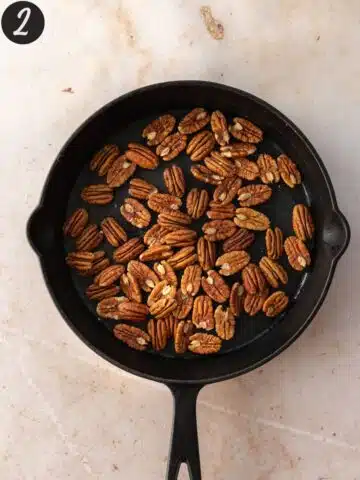 pecans toasting in a skillet.