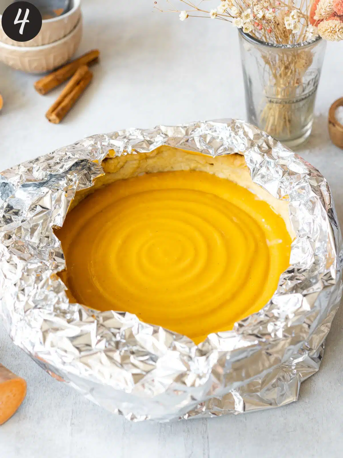 sweet potato pie with foil tent around the crust.