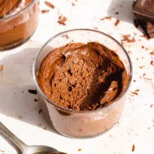 dairy-free chocolate mousse in a small glass jar with chocolate shavings.