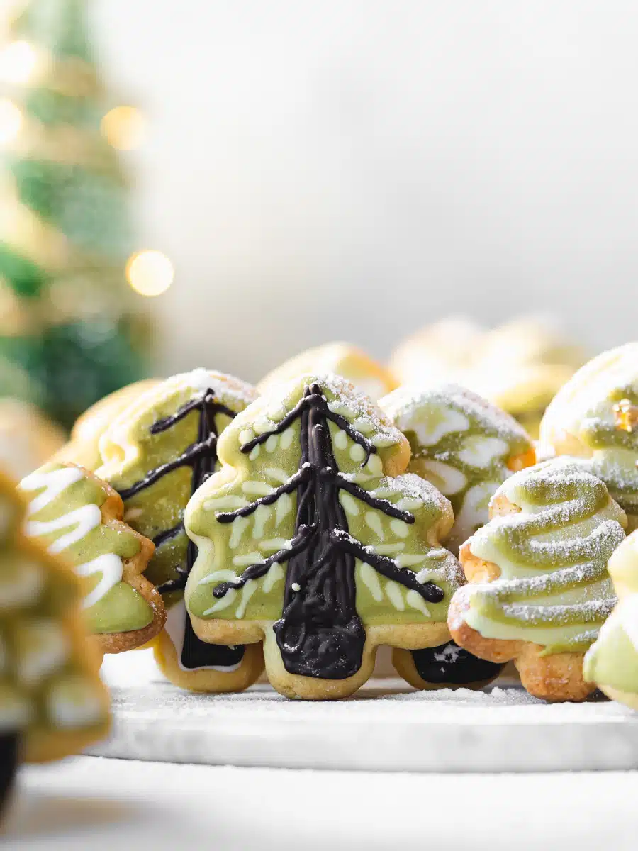 christmas tree cookies with icing sugar dusted over them.