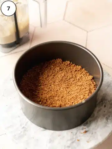 Cinnamon sugar mixture distributed in an even layer over the cheesecake filling.