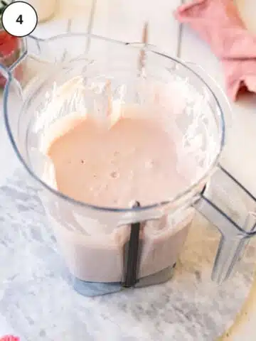 creamy strawberry cheesecake filling in a blender jug.