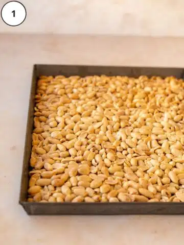 Roasted skinless peanuts on a rimmed sheet pan.
