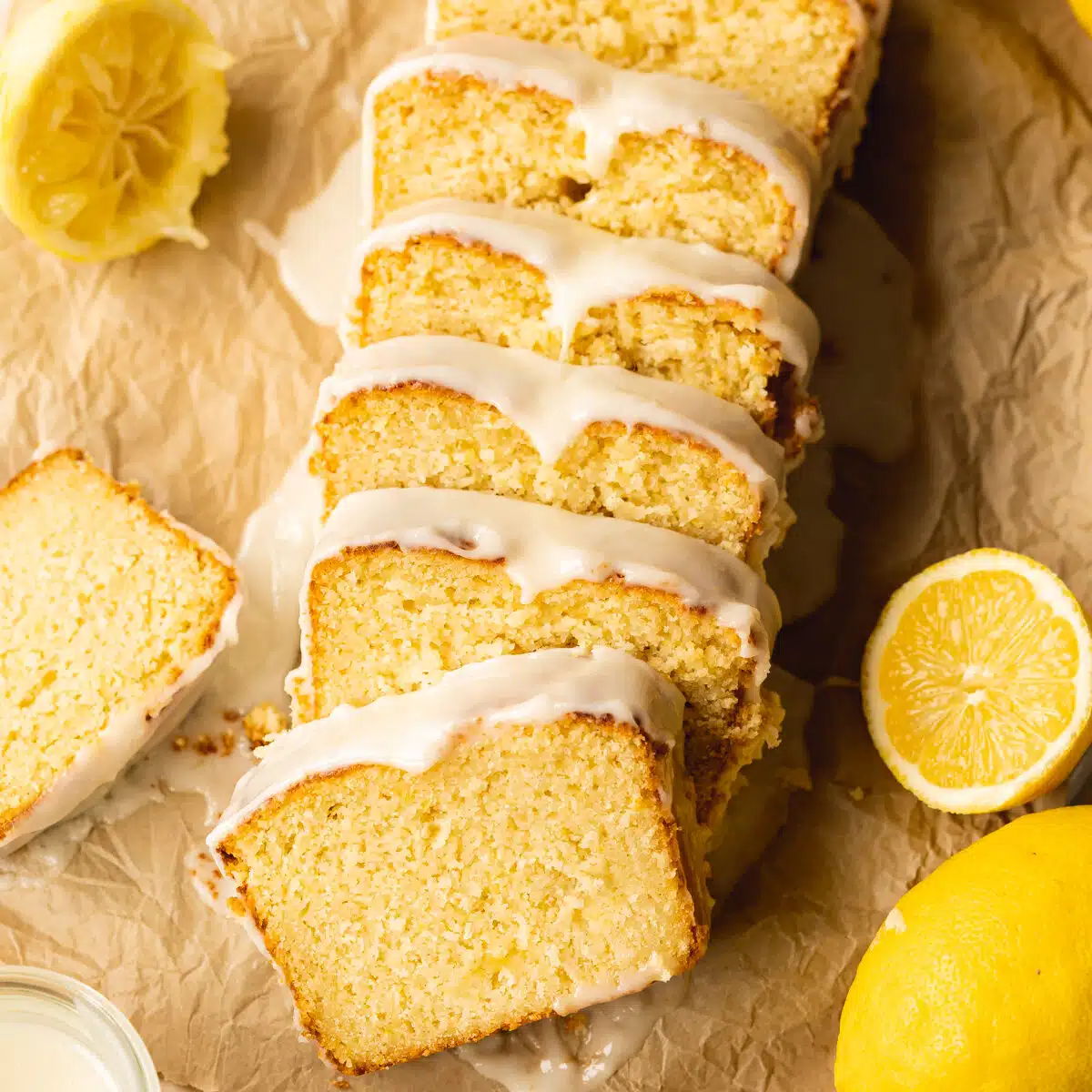 overhead shot of vegan lemon loaf sliced into pieces and toppled over to show the soft and tender crumb.