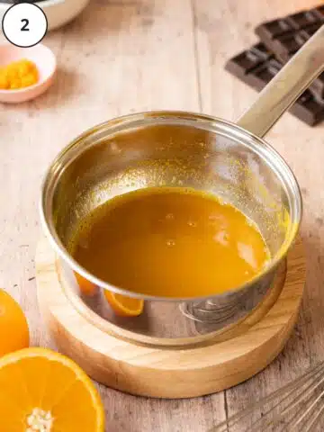 Reduced orange juice after adding sugar and cooking to an orange reduction.