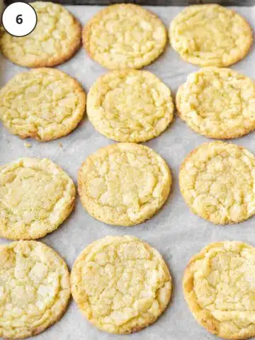 Baked key lime cookies on a parchment-lined sheet pan.