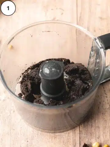 Pulsing oreo cookies in a food processor with salt.