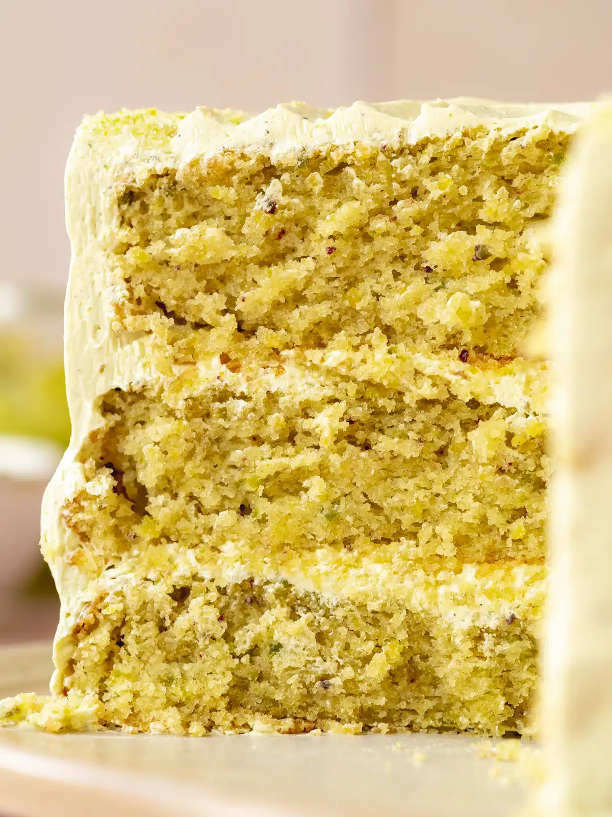 closeup of a vegan pistachio layer cake showing the light and fluffy consistency.