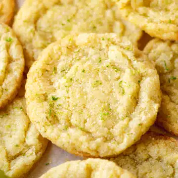 closeup shot of a golden-brown key lime cookie rolled in lime zest and sugar for added sparkle and flavor.