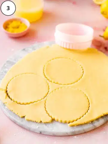 Cutting out rounds of rolled vegan tart dough.