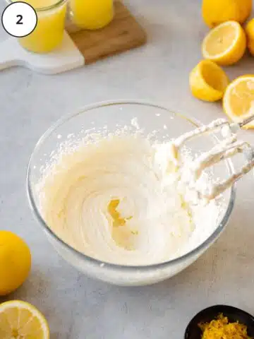 Whipped butter and cream cheese in a mixing bowl.