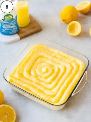 Lemon curd neatly piped over the chilled lemony cheesecake filling.