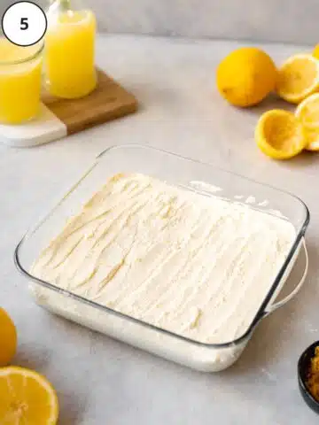 Lemony cream cheese mousse spread on top of the cookie layer in the baking pan.