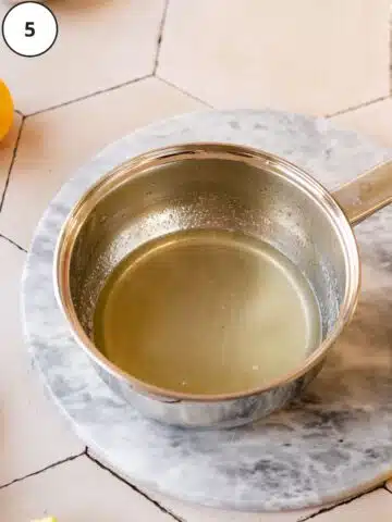 freshly made lemon syrup in a saucepan.