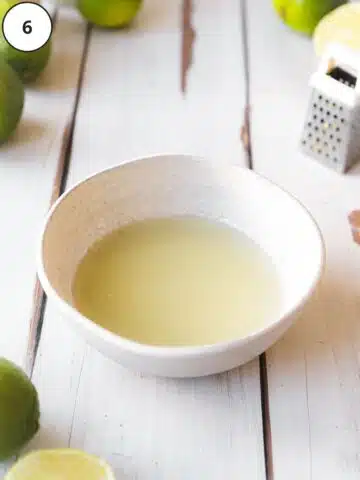 Lime glaze ingredients whisked together in a white bowl.