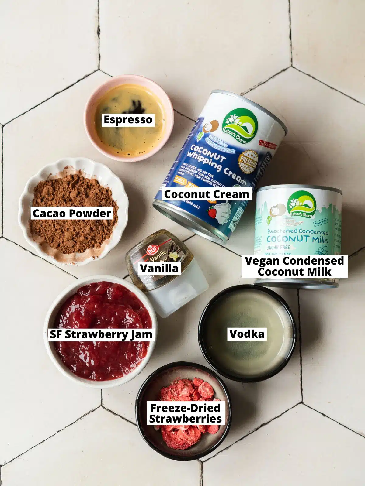 ingredients for vegan neapolitan ice cream cake measured out in bowls on a tiled surface.
