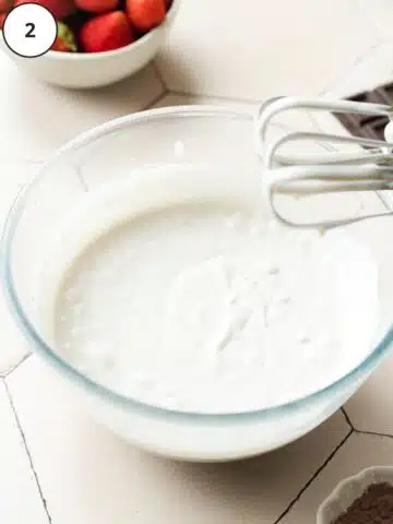 no churn vanilla ice cream whisked in a large mixing bowl.