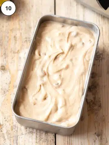 Churned rum raisin ice cream has been packed into a loaf tin after churning.