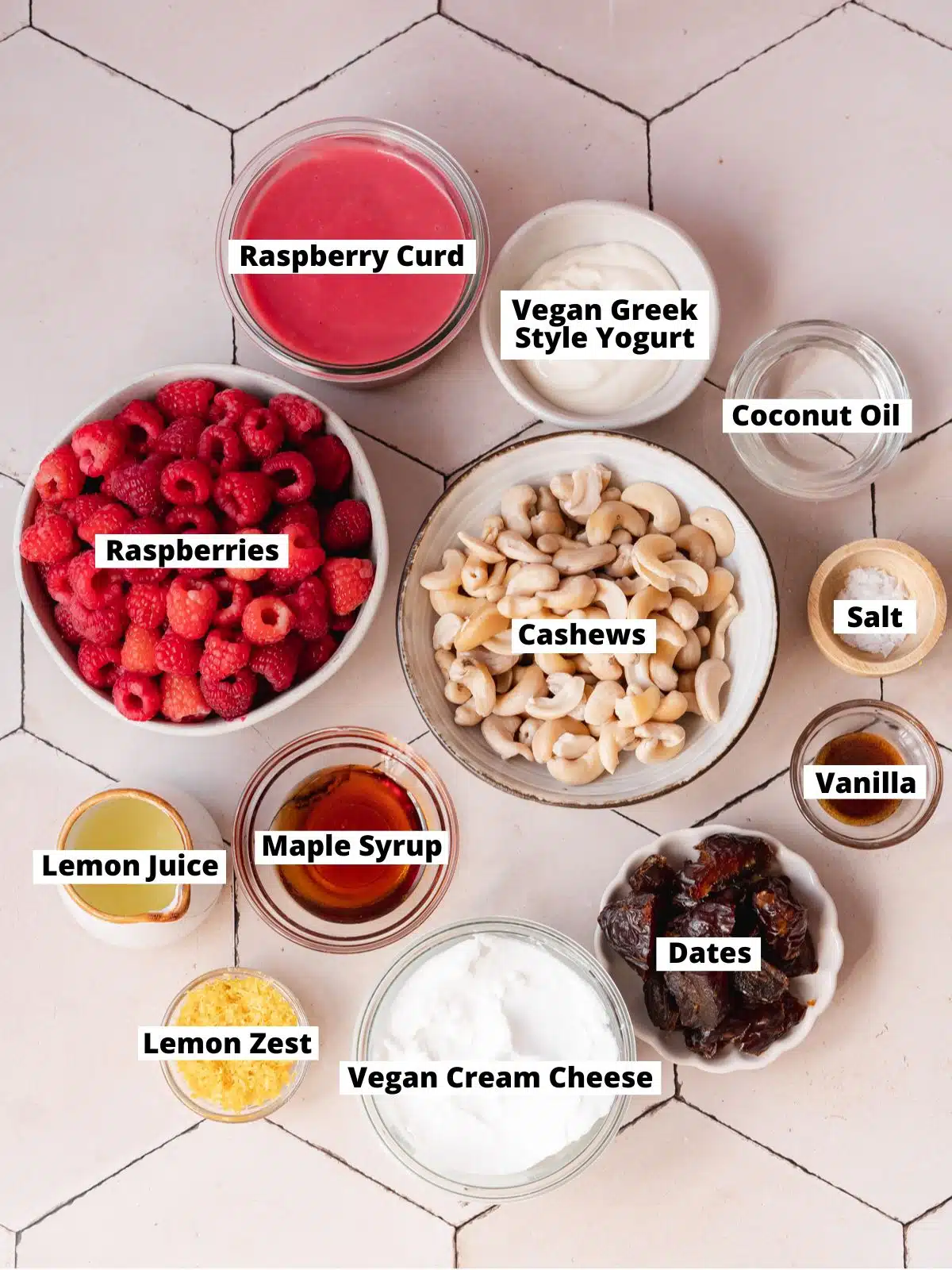 ingredients to make no bake raspberry cheesecake bars measured out in bowls on a tiled surface.