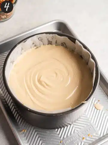 creamy no-bake cheesecake filling in a lined cake pan before going into the fridge to set.