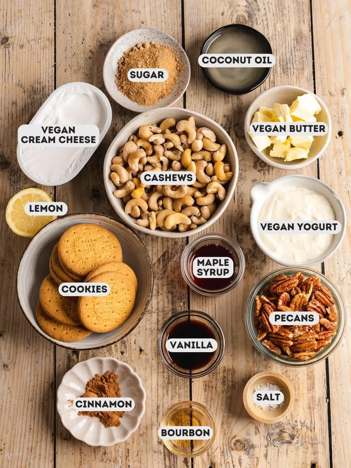ingredients to make pecan cheesecake measured out in bowls on top of a wooden table with text overlay.