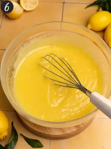 lemon curd filling in a bowl with a whisk for lemon meringue pie.