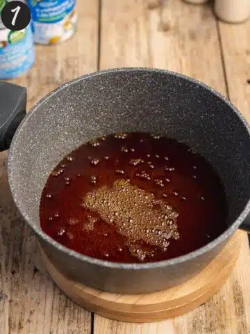 a saucepan with caramel ready to pour into a flan dish.