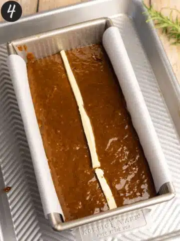 gingerbread cake in a loaf pan before baking with a thin strip of vegan butter in the middle.