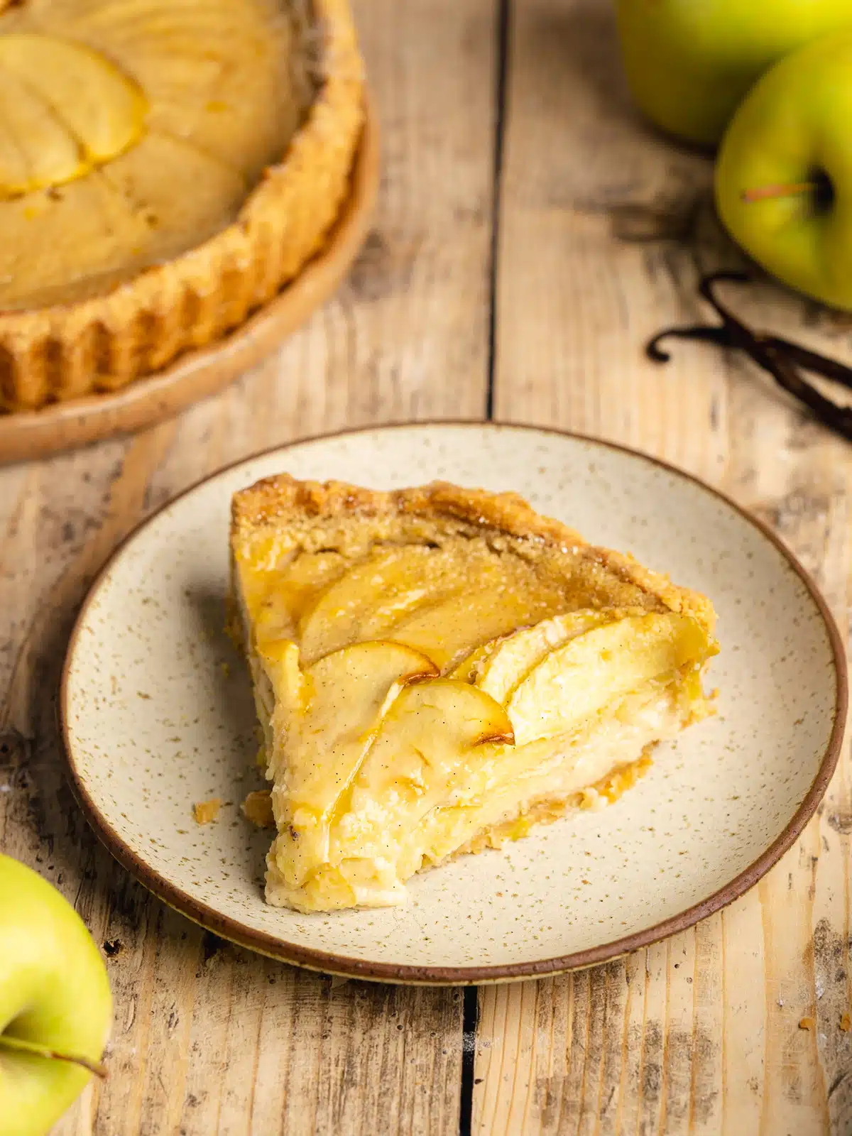 This vegan apple custard tart features a buttery shortcrust pastry, a dreamy vanilla custard, and thin slices of tender-sweet apples. An eggless and dairy-free spin on Tarte Normande that looks like a million bucks but is a snap to make!