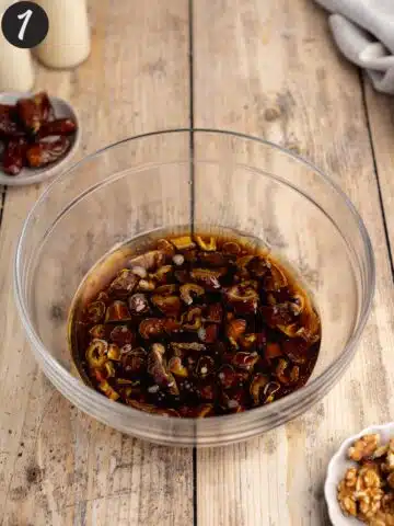 dates and baking soda soaking in coffee and olive oil in a large clear bowl.
