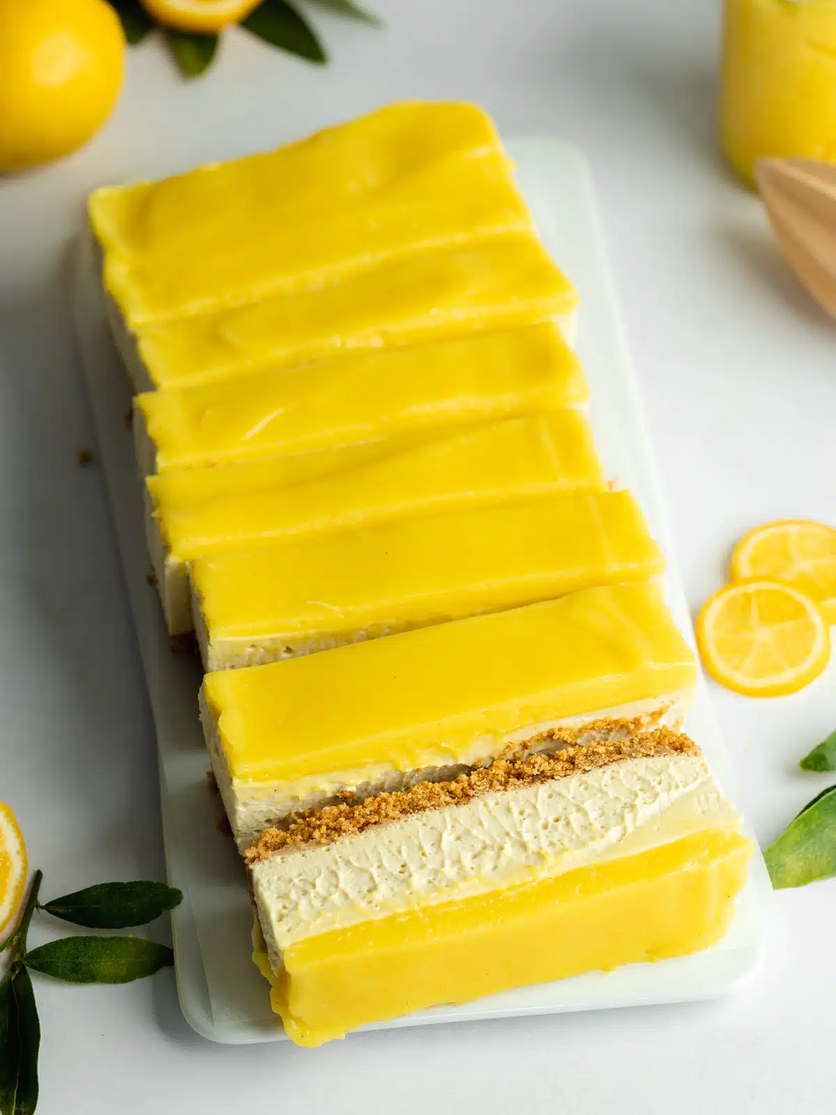 cheesecake with lemon curd topping thats been made in a loaf pan and cut into slices.