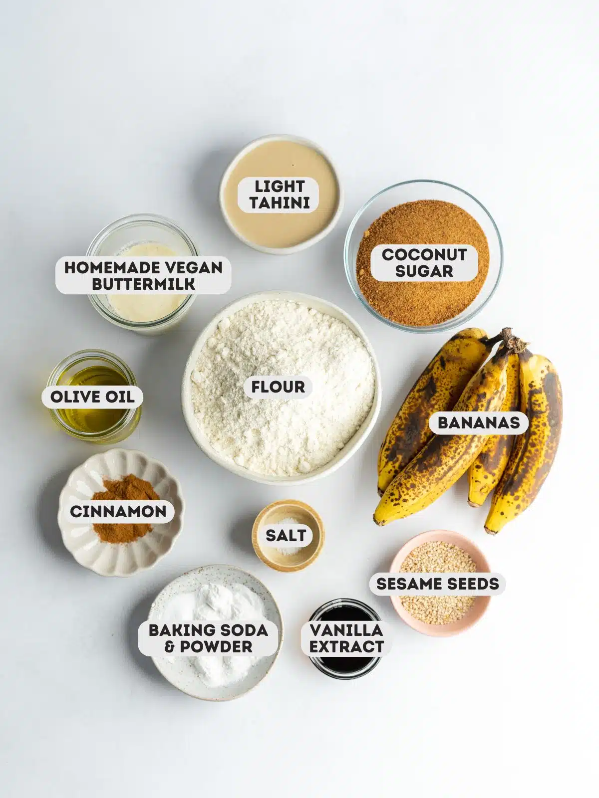 ingredients to make vegan tahini banana bread measured out in bowls on a gray surface.