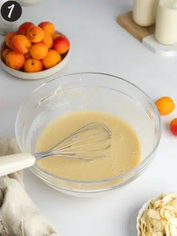 wet ingredients for apricot cake whisked in a bowl.