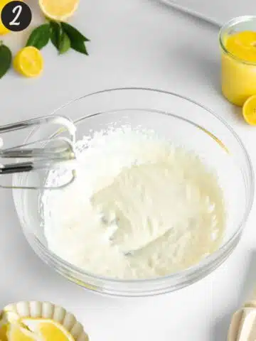 vegan yogurt and cream cheese whipped until fluffy in a bowl with an electric mixer.