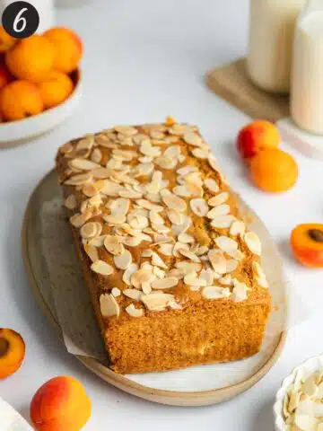 apricot and almond cake cooling on a plate.