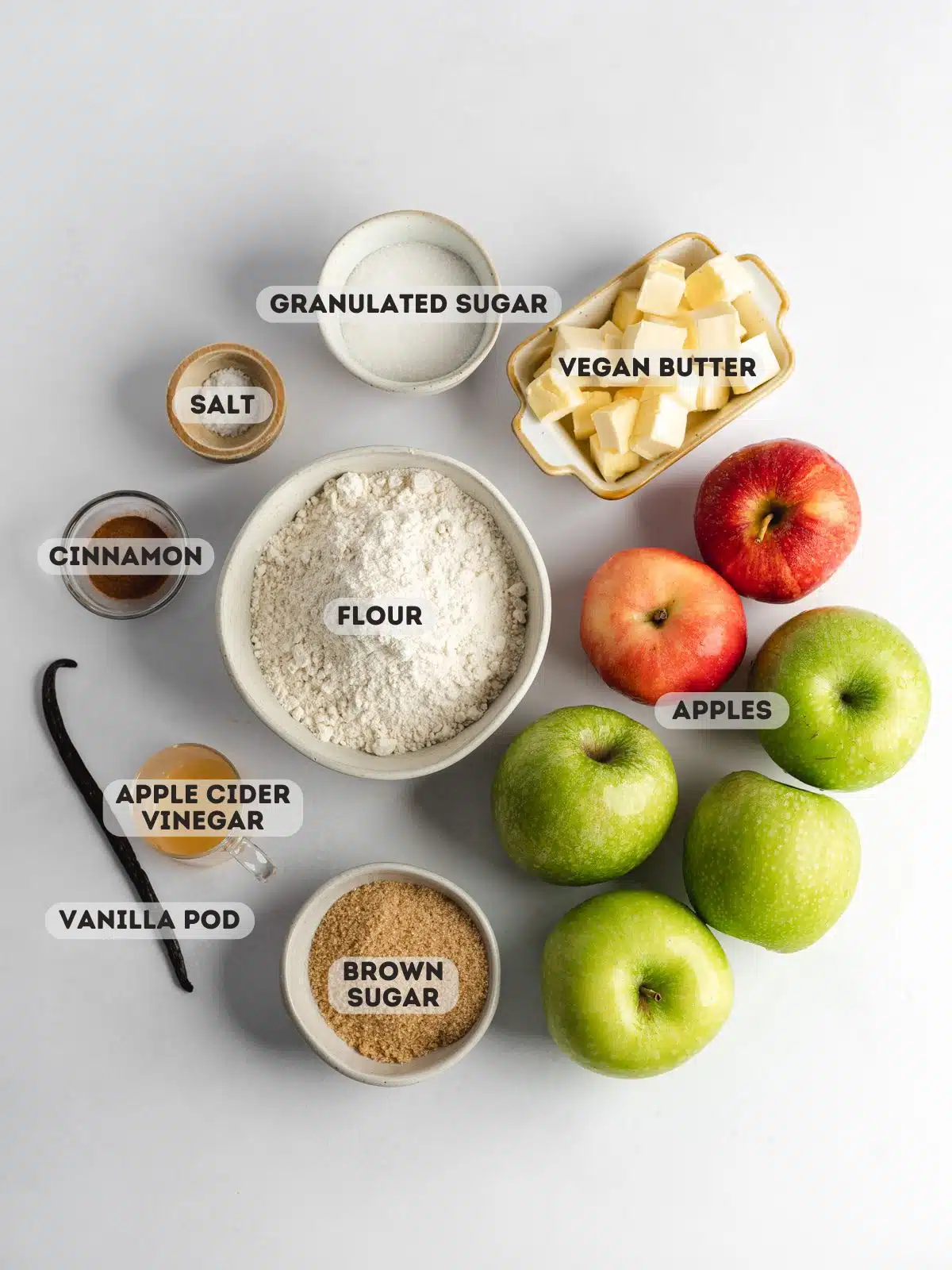 ingredients to make apple crumble measured out in mixing bowls with a text overlay.