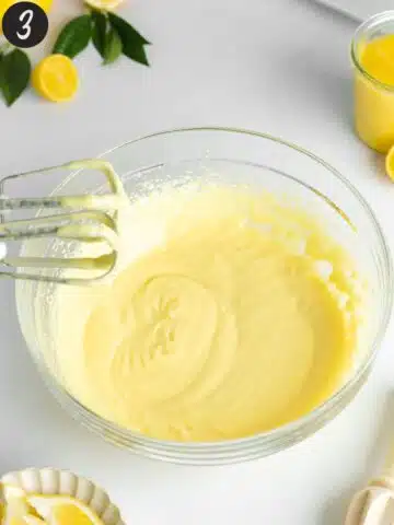 vegan cream cheese, yogurt, and homemade lemon curd whisked in a bowl with an electric mixer.