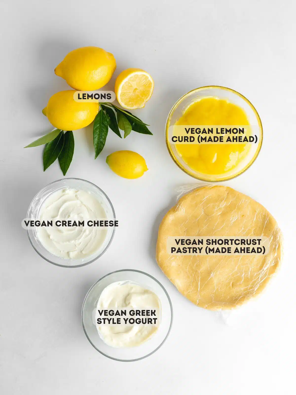 ingredients to make vegan lemon tart measured out in bowls on a light gray surface with text overlay.