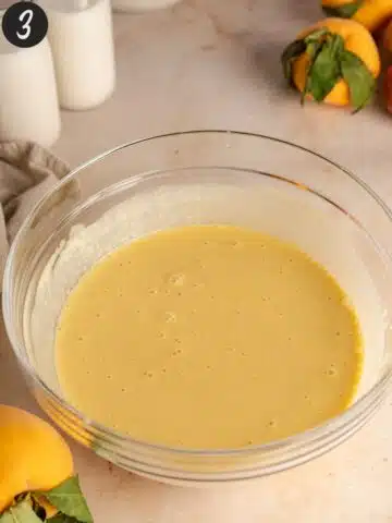 a large mixing bowl with peach puree, olive oil, soy milk, vinegar, vanilla extract, yogurt, and sugar whisked until smooth.