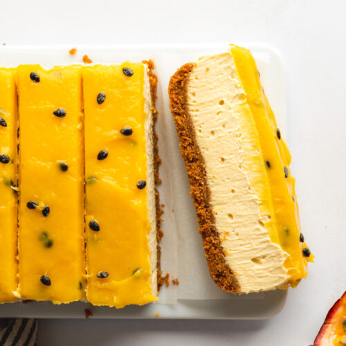 passion fruit cheesecake slices with no-bake cookie crust showing the smooth and creamy interior.