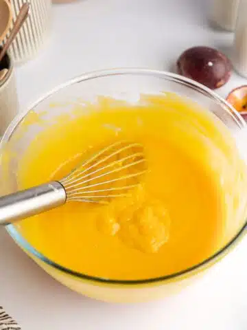 passion fruit curd with butter whisked until thick in a large mixing bowl.